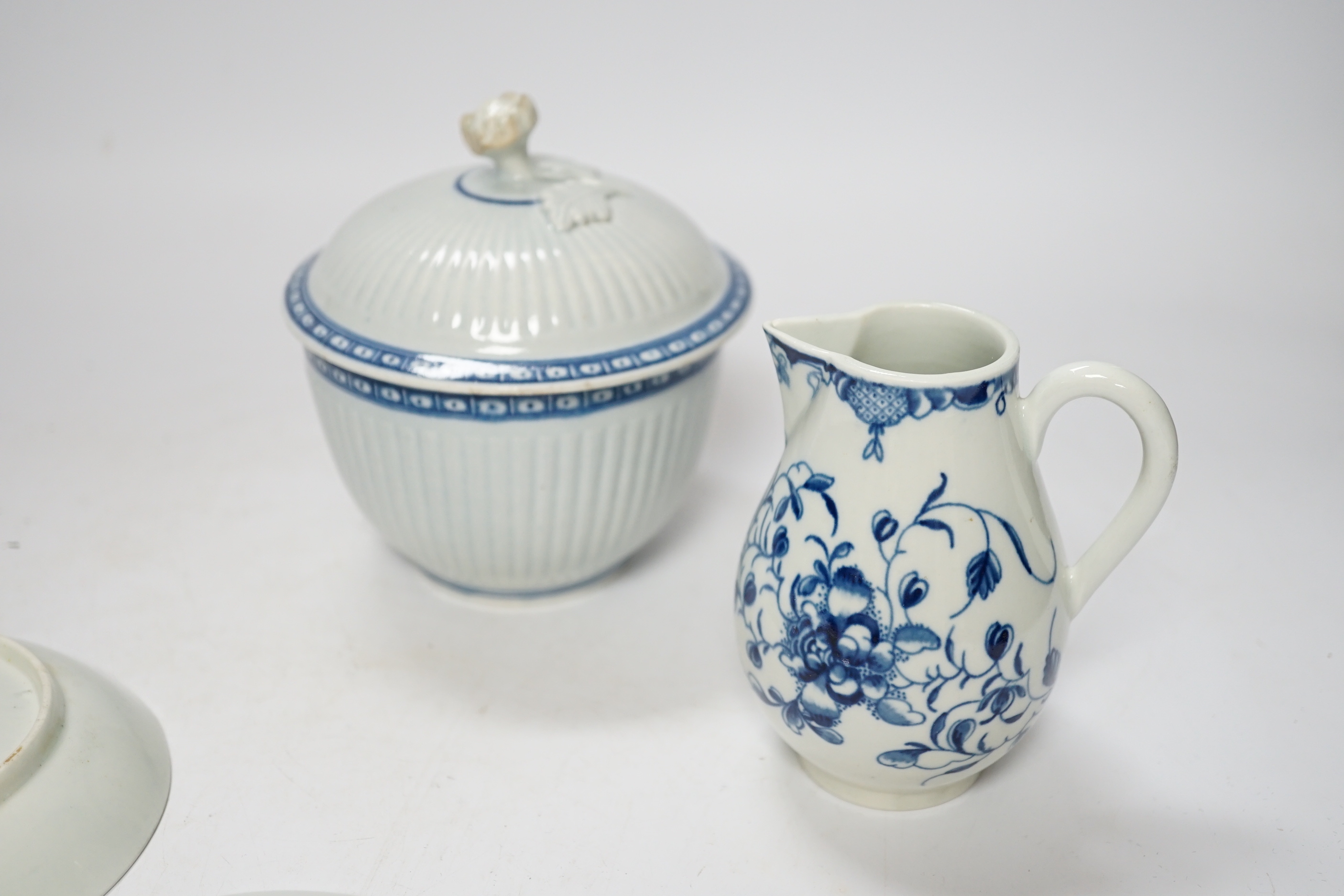 A Worcester Mansfield pattern sparrow beak milk jug, two saucers and a Worcester sucrier and cover, late 18th century